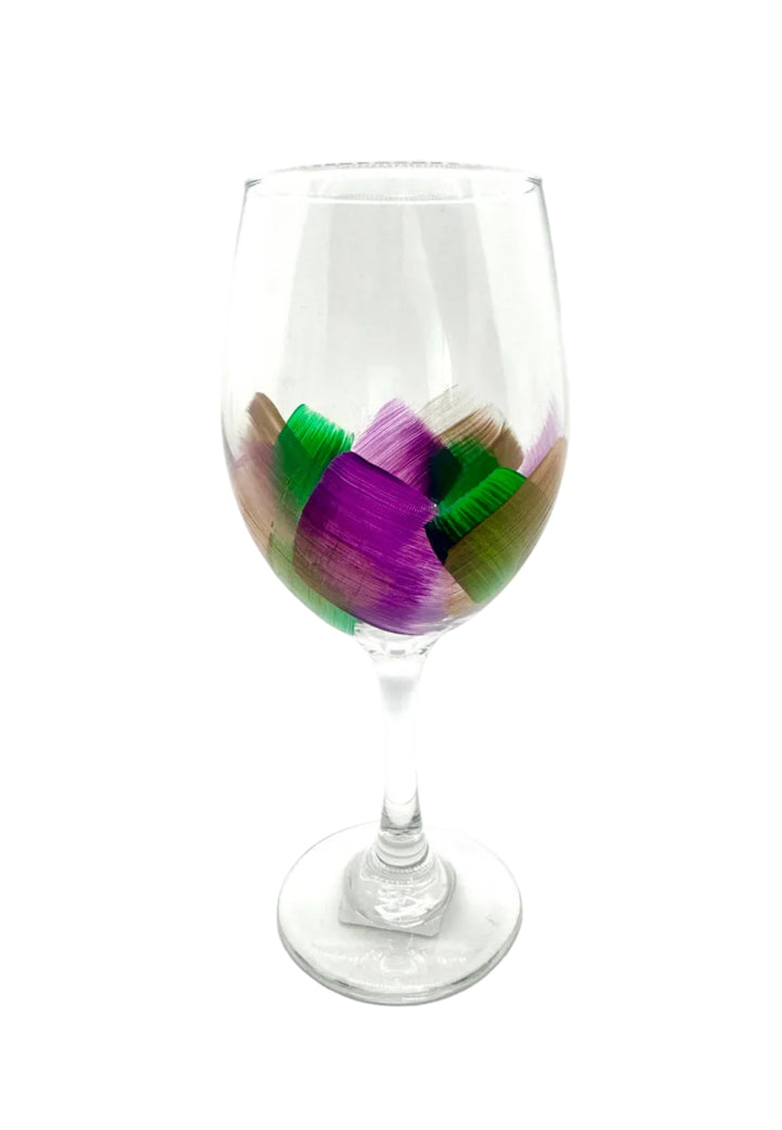 Wine glass with colorful brushstroke design on a white background