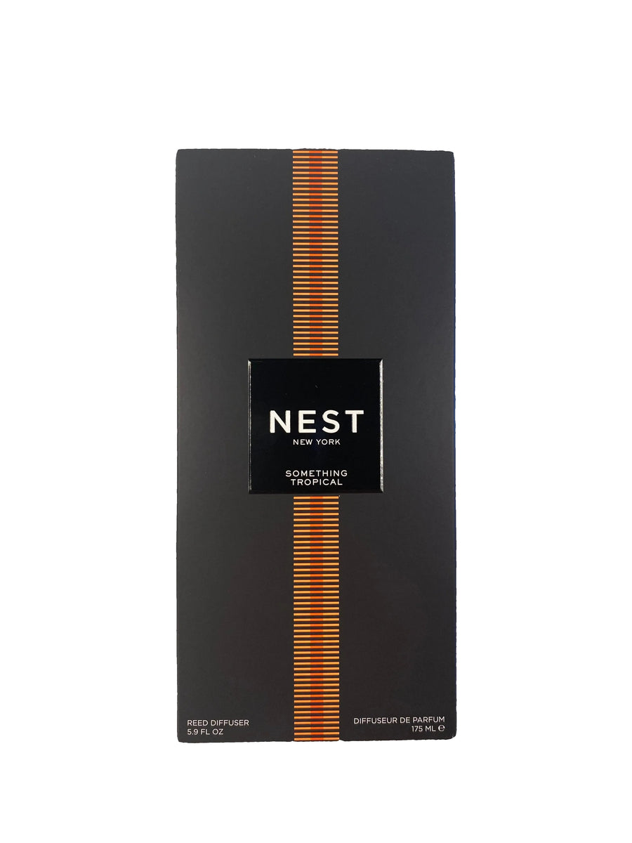 Black NEST product box with orange accents on a marble surface