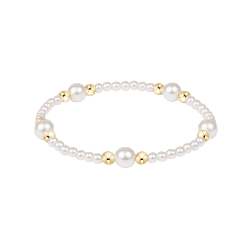 Pearl bracelet with gold beads on a white background