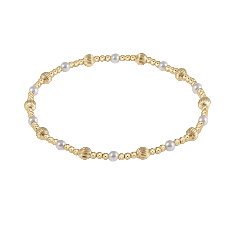 Gold and pearl beaded necklace on a white background