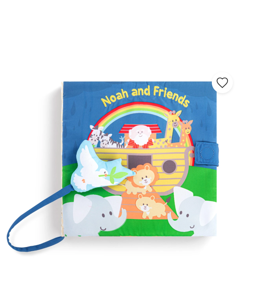 A children's fabric book titled 'Noah and Friends' featuring a colorful illustration of Noah's ark, animals, and a rainbow. The book has a blue strap closure and a blue hanging loop with a green leaf, shown on a plain white background.